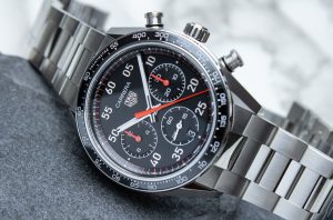 Close-up of a black Carrera Sport style chronograph dial with red accents