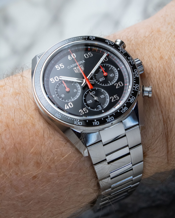 Carrera Sport style chronograph and steel bracelet worn on a wrist